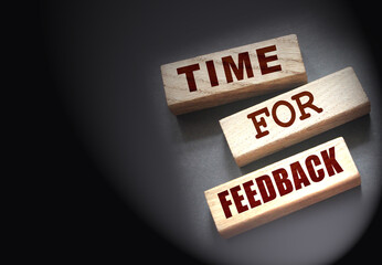 Time fir feedback text on wooden blocks. Product or service evaluation and clients feedback in...