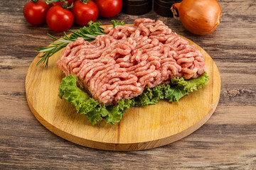 Raw pork minced meat over board
