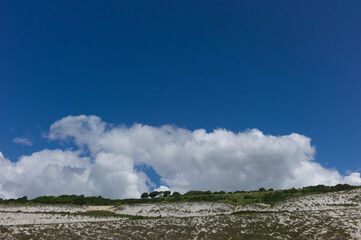 White clouds and blue sky above white cliffs of Dover in the United Kingdom  seen from the sea 