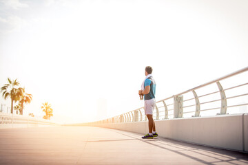 Sportive athletic man running outdoors