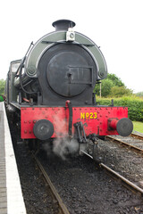 Obraz premium Front view of a USA 0-6-0T class steam locomotive on the Kent and East Sussex Railway in Tenterden, Kent