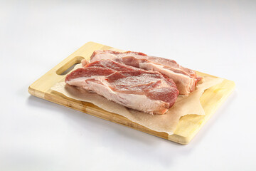 Raw pork fillet over board