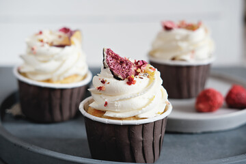 close up view of home made cupcakes with creamcheese frosting and dry figs decoration. selective focus. summer party menu