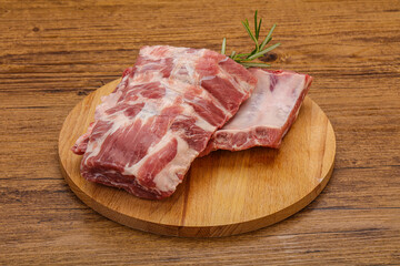 Raw pork ribs served rosemary