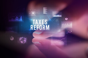 Finger touching tablet with business graphs and icons concept