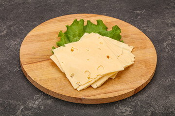 Sliced yellow cheese over board