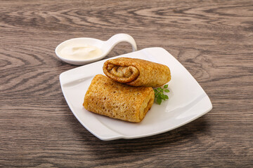 Staffed pancakes served sour cream