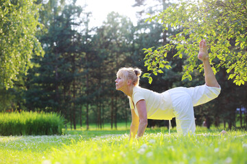 Naklejka premium Yoga woman in park