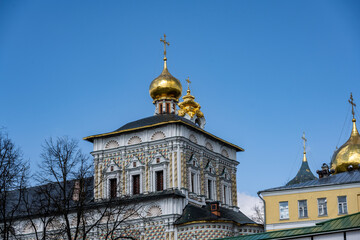 Fototapeta na wymiar golden towers and ancient architectural solutions of the Trinity-Sergievskaya Lavra in Sergiev Posad on a sunny spring day