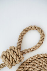 Braided thick rope tied in a skein. Hemp rope for decoration and design. Background from a fishing rope.