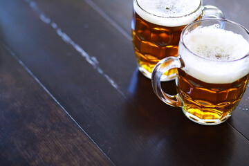 Glass of fresh beer on a wooden table. Lager beer mug on stone table. Top view with copy space