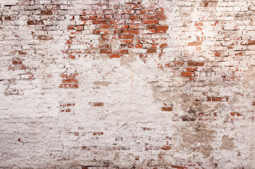 Abstract red white stonewall urban texture. Old red brick wall with shabby damaged white plaster....