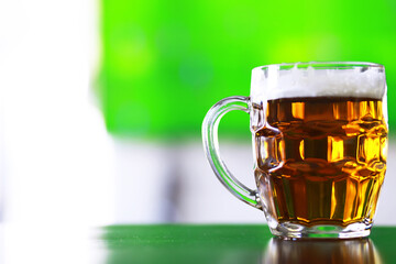 Glass of fresh beer on a wooden table. Lager beer mug on stone table. Top view with copy space