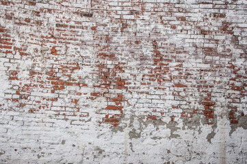 Abstract red white stonewall urban texture. Old red brick wall with shabby damaged white plaster. Painted whitewashed brickwall grungy background. Stonework frame grunge empty wallpaper.