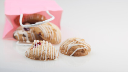 cookies glazed in pink shopping bag on a white background. The concept of copy space.