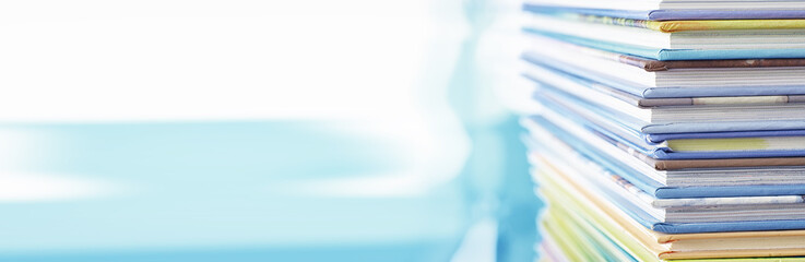 A stack of books. Textbooks on the table. Tutorials are on the desk.