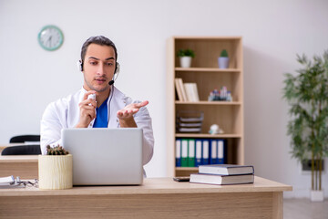 Young male doctor in telemedicine concept