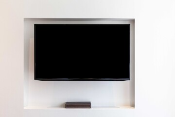 A modern flat screen TV on the wall