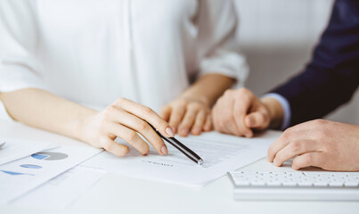 Unknown businessman and woman discussing contract in office. closeup.Business people or lawyers working together at meeting. Teamwork and partnership