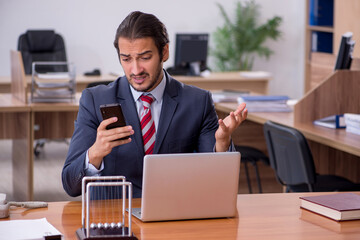 Young man businessman employee sitting in the office