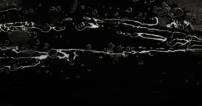 Black abstract background. Oil ink or black paint moving and luminating the light. Coal tar textured backdrop concept