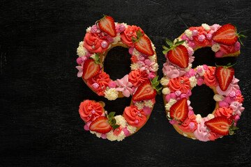 Beautiful cake in the shape of number 96. Modern trendy design. Springtime decoration. Copy space. Low key. Unusual bright dessert. Birthday card.