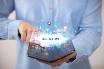 Businessman holding a foldable smartphone, technology concept