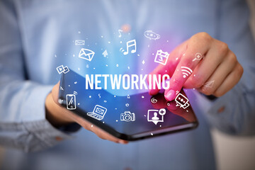 Businessman holding a foldable smartphone, social media concept