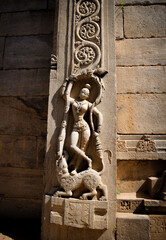 A Dancing girl stone idol on a temple exterior which has been carved delicately, a symbolic representation of Indian history in stone, a perfect destination for tourist visiting Karnataka.