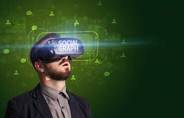 Businessman looking through Virtual Reality glasses, social media concept