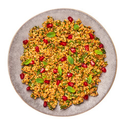 Kisir on gray plate isolated on white. Turkish cuisine bulgur and parsley salad dish with pomegranate. Turkish food and meal.