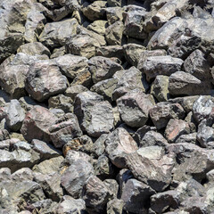 Endless seamless pattern from Bulk of coarse gravel on a harbour basin.