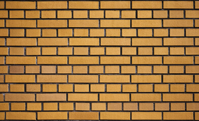 a wall built of yellow bricks creates an abstract background