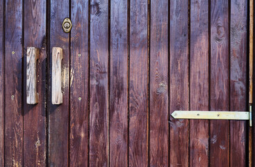 old wooden door with planks painted brown