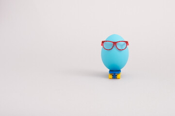 Creative  funny concept with blue egg wearing eyeglasses and riding skateboard
