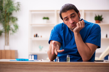 Fototapeta premium Young male doctor in vaccination concept
