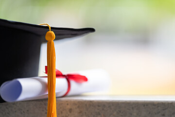 Close-up of a mortarboard and degree certificate put on table. Education stock photo - obrazy, fototapety, plakaty