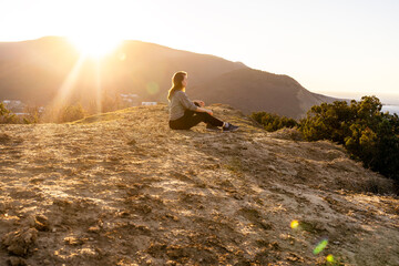 Woman looking on the mountains and sunrize