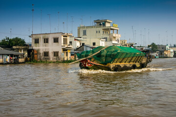 Naklejka premium Transport ship on the Mekong River in Cai Be, Mekong Delta, Vietnam, Southeast Asia