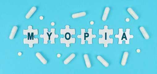 On a blue background, there are pills and puzzles with the inscription - MYOPIA