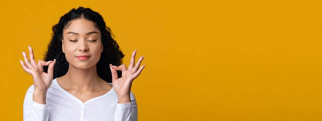Zen. Relaxed Young African American Lady Meditating With Closed Eyes, Yellow Background