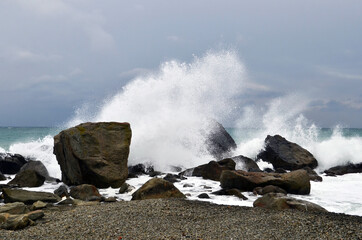 waves crash on stones