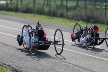 Couple of Disabled Athlete training with Their Hand Bikes on a Track