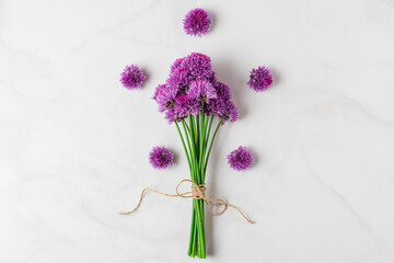 Purple alium wildflowers bouquet on white background. top view. flat lay. festive background