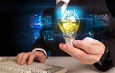 Businessman holding a light bulb, online security concept