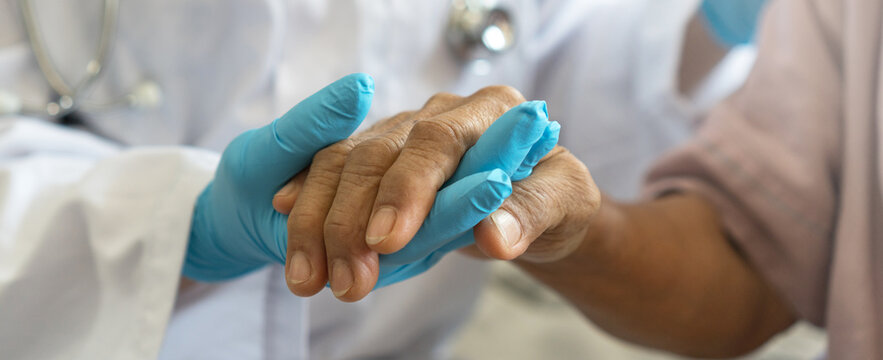 Parkinson And Alzheimer Female Senior Elderly Patient With Physician Doctor In Hospice Care.