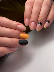 The work of a manicure master. Hands of a beautiful young woman and modern design.