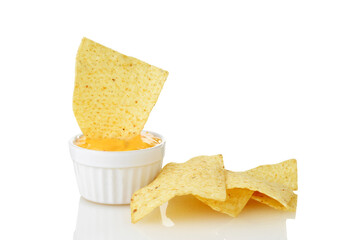 nacho chip dipped in bowl of cheese