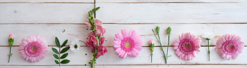 Mothers day floral background with pink gerbera blossoms on white vintage planks for greetings....