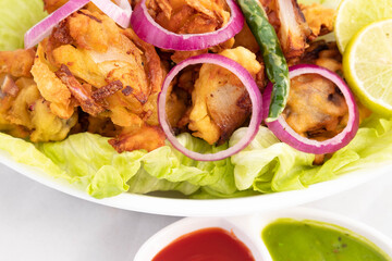 Onion Pakoda Also Known As Kanda Bhajji, Pyaj Ke Pakode, Pakoda, Pyaaj Pakore, Pakora, Pyaaz Bajji Is Enjoyed In Rainy Season Across North And South India. Served With Green Chutney And Ketchup Sauce